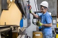 A factory worker manufacturing products on an assembly line.